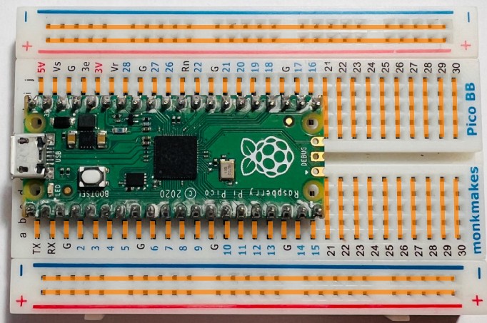 Breadboard with colored lines showing internal electrical connections